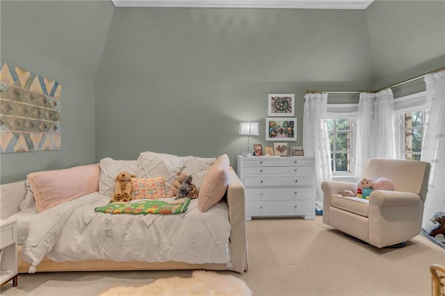 carpeted bedroom with high vaulted ceiling