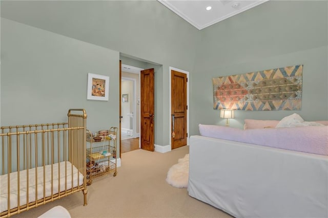 bedroom with crown molding and light colored carpet