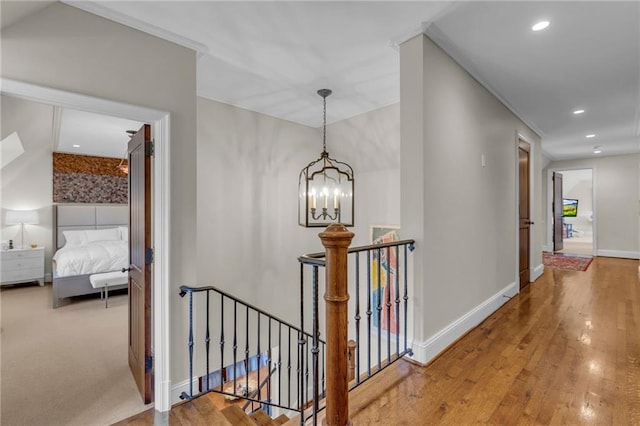 hall with a chandelier and wood-type flooring