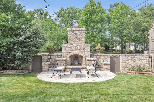 view of patio / terrace featuring an outdoor stone fireplace