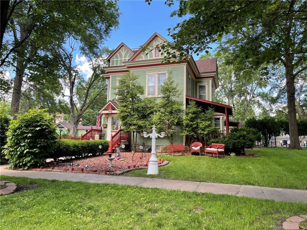 victorian home with a front lawn