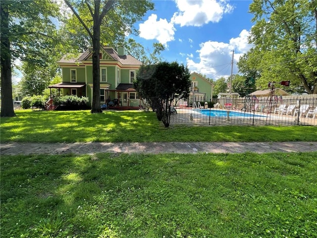 view of yard with a fenced in pool