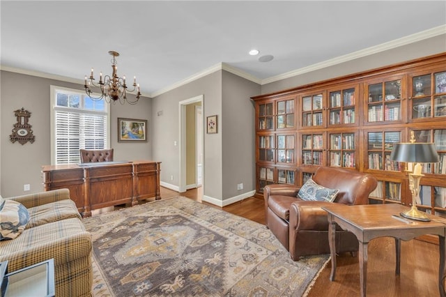 living area with ornamental molding, hardwood / wood-style flooring, and an inviting chandelier