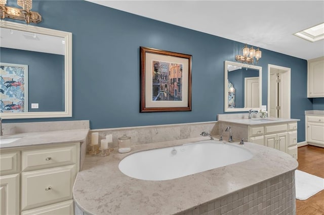 bathroom featuring vanity, hardwood / wood-style floors, and a bathing tub