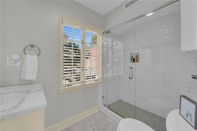 bathroom with vanity, toilet, and an enclosed shower