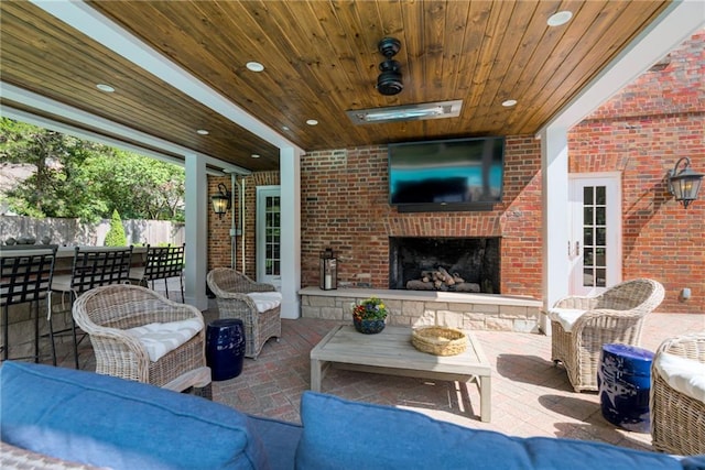 view of patio / terrace with an outdoor living space with a fireplace