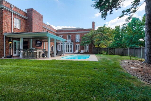 exterior space with a patio area and a lawn