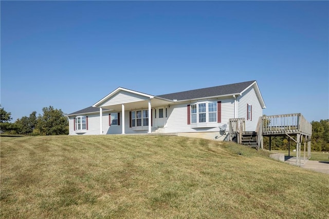 ranch-style home with a front lawn and a deck