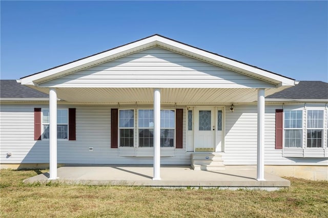 rear view of property with a yard and covered porch