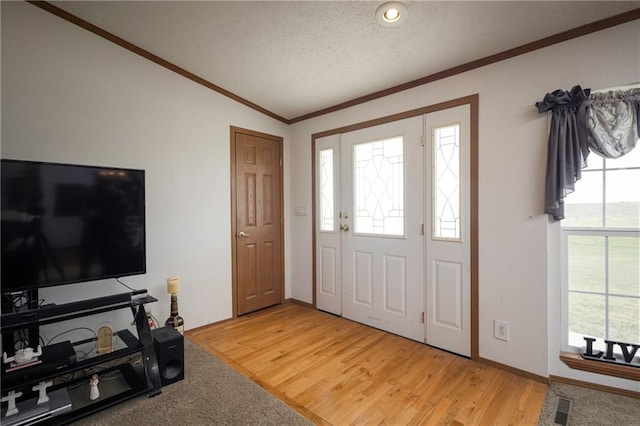 entryway featuring hardwood / wood-style flooring, a wealth of natural light, and a textured ceiling