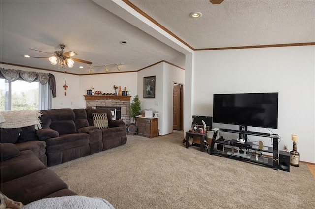 carpeted living room featuring a fireplace, ceiling fan, crown molding, and a textured ceiling