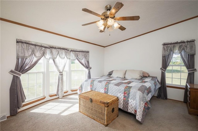 bedroom with lofted ceiling, light carpet, multiple windows, and ceiling fan