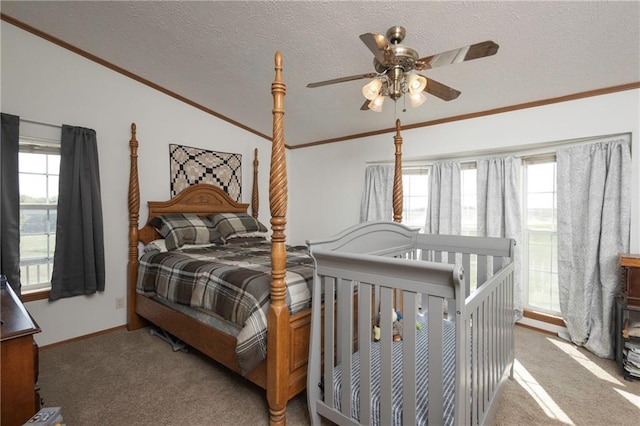 carpeted bedroom featuring ornamental molding, ceiling fan, vaulted ceiling, and a textured ceiling