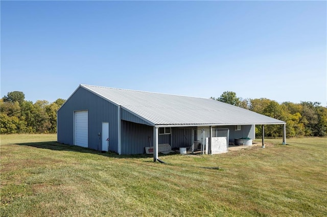 view of outdoor structure with a lawn and a garage