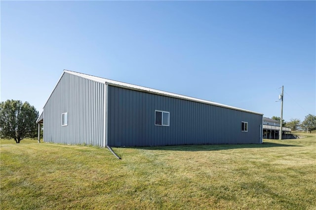 view of outbuilding featuring a yard