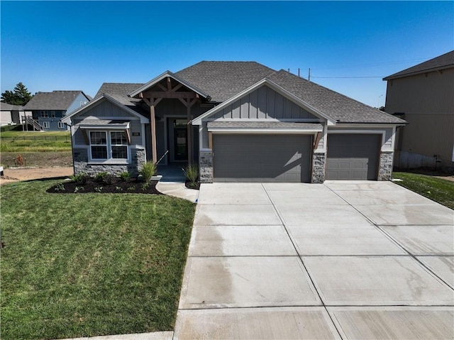 craftsman-style home featuring a front yard and a garage