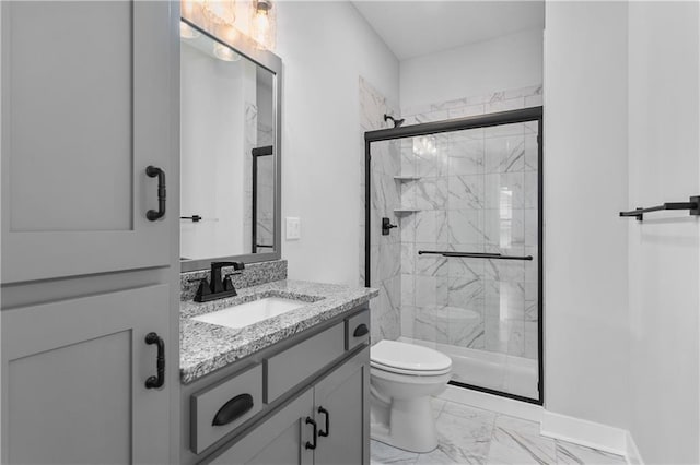 bathroom with vanity, toilet, and a shower with door