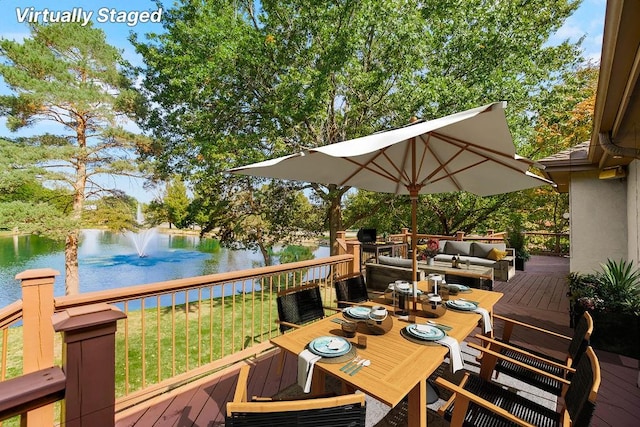 wooden deck featuring a water view