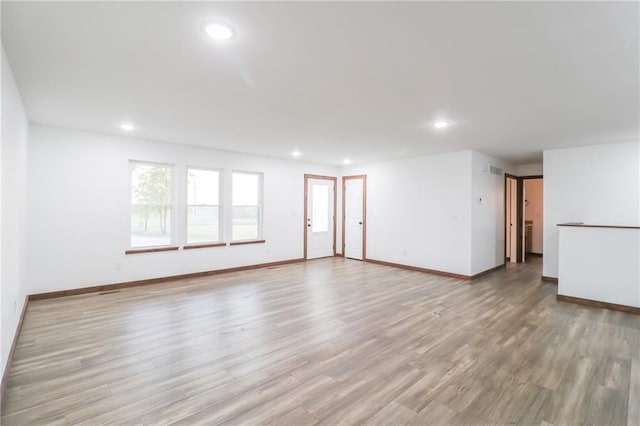 unfurnished living room featuring light hardwood / wood-style floors