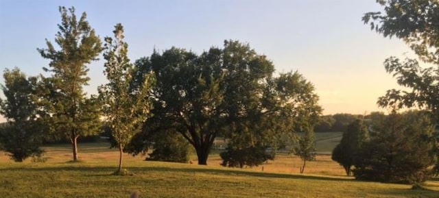 nature at dusk featuring a rural view