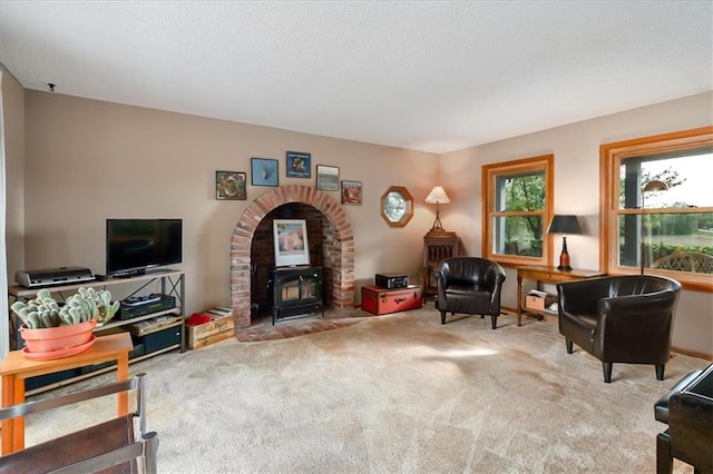 living room featuring carpet flooring and a wood stove