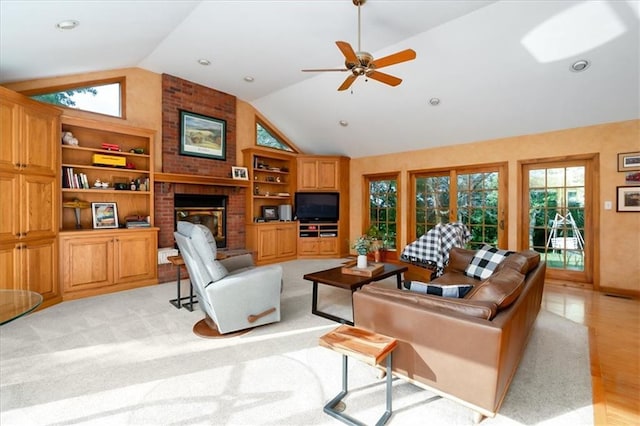 living room featuring lofted ceiling, ceiling fan, light hardwood / wood-style flooring, built in features, and a fireplace