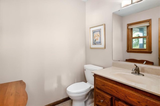 bathroom featuring toilet and vanity