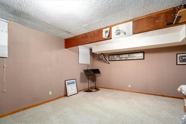 basement featuring a textured ceiling and carpet floors