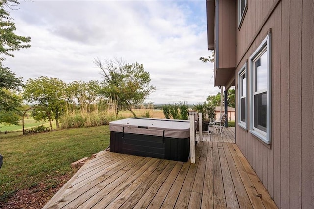 wooden terrace with a hot tub and a yard