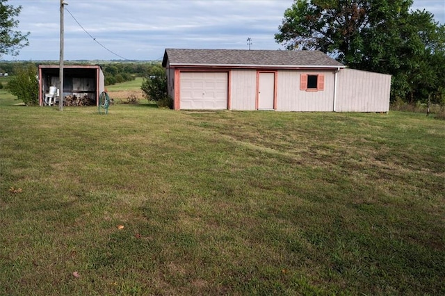 view of yard featuring an outbuilding and a garage