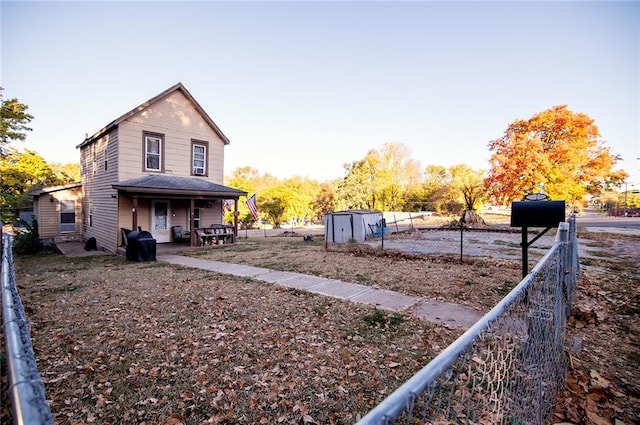 back of property with a shed