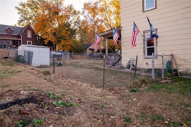 929 N 7th St, Atchison, KS 66002 - view of yard with fence, a storage shed, and an outdoor structure