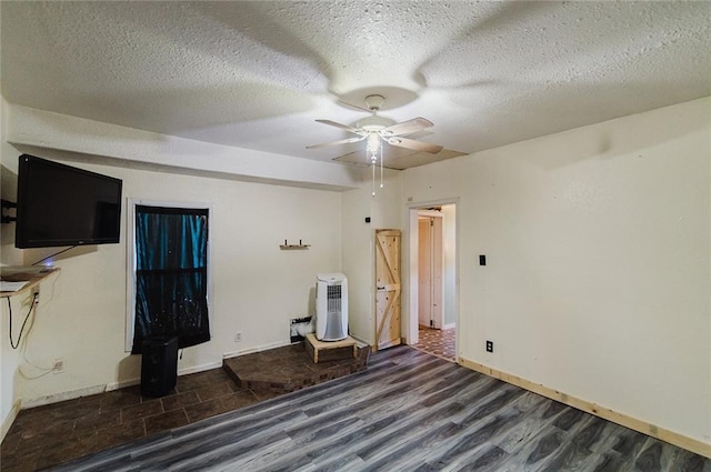 929 N 7th St, Atchison, KS 66002 - spare room with wood finished floors, a ceiling fan, a textured ceiling, and baseboards