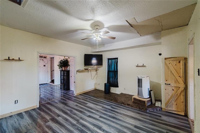 929 N 7th St, Atchison, KS 66002 - unfurnished living room featuring wood finished floors, a ceiling fan, baseboards, and a textured ceiling