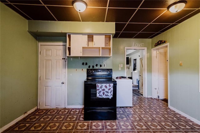 929 N 7th St, Atchison, KS 66002 - kitchen with black electric range, open shelves, and baseboards