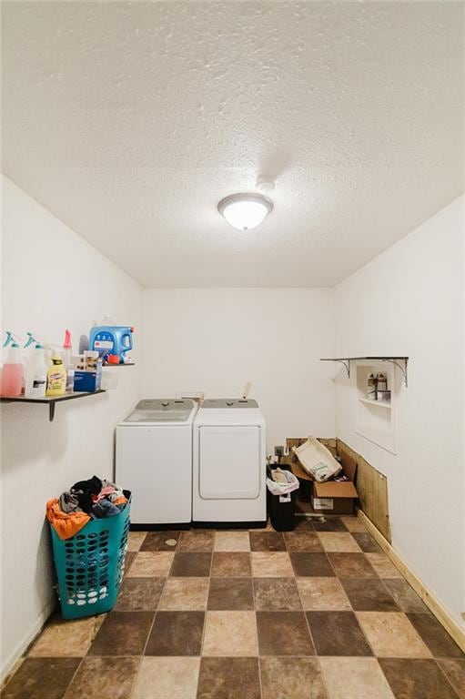 929 N 7th St, Atchison, KS 66002 - laundry area with washer and dryer, stone finish flooring, a textured ceiling, and baseboards