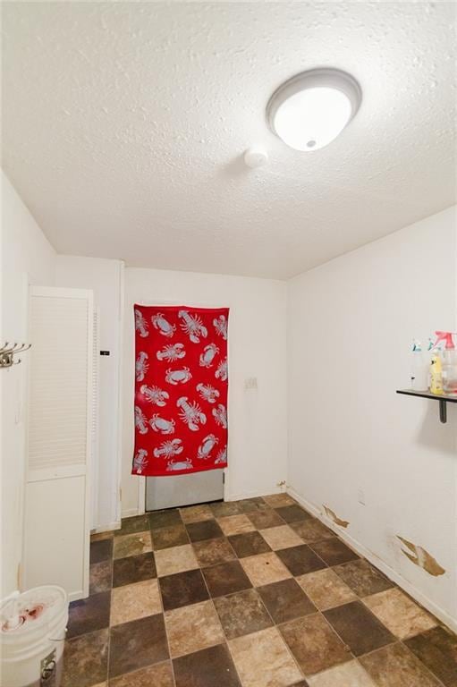 929 N 7th St, Atchison, KS 66002 - spare room featuring a textured ceiling and stone finish floors