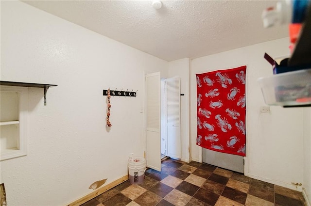 929 N 7th St, Atchison, KS 66002 - laundry room with baseboards and a textured ceiling