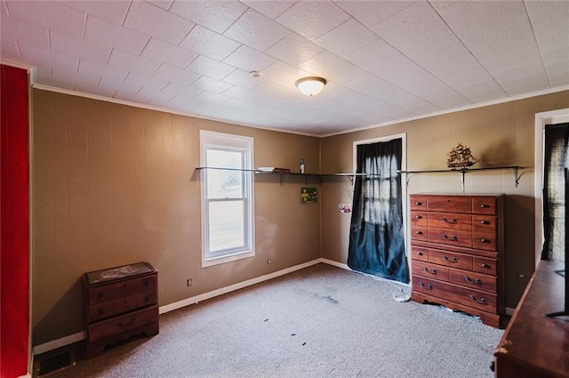 929 N 7th St, Atchison, KS 66002 - unfurnished bedroom featuring carpet flooring, ornamental molding, wood walls, and baseboards