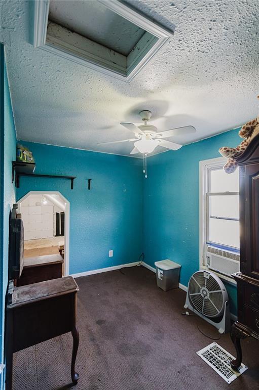 929 N 7th St, Atchison, KS 66002 - interior space with a textured ceiling, carpet floors, a ceiling fan, baseboards, and cooling unit