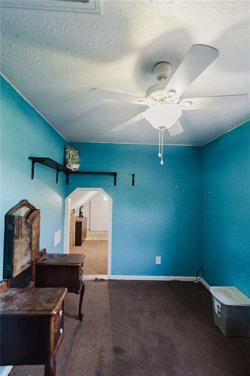 929 N 7th St, Atchison, KS 66002 - unfurnished office with carpet, a ceiling fan, baseboards, and a textured ceiling
