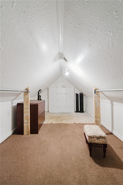 929 N 7th St, Atchison, KS 66002 - additional living space with a textured ceiling, lofted ceiling, and carpet flooring