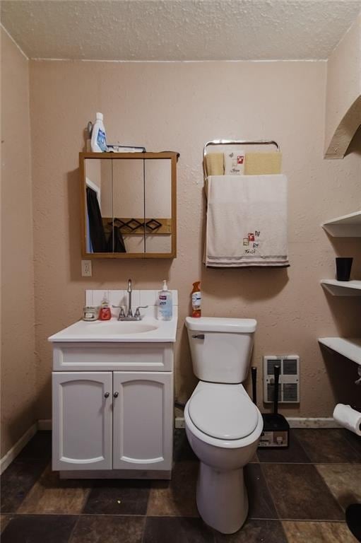 929 N 7th St, Atchison, KS 66002 - half bathroom with a textured ceiling, vanity, toilet, baseboards, and stone finish floors