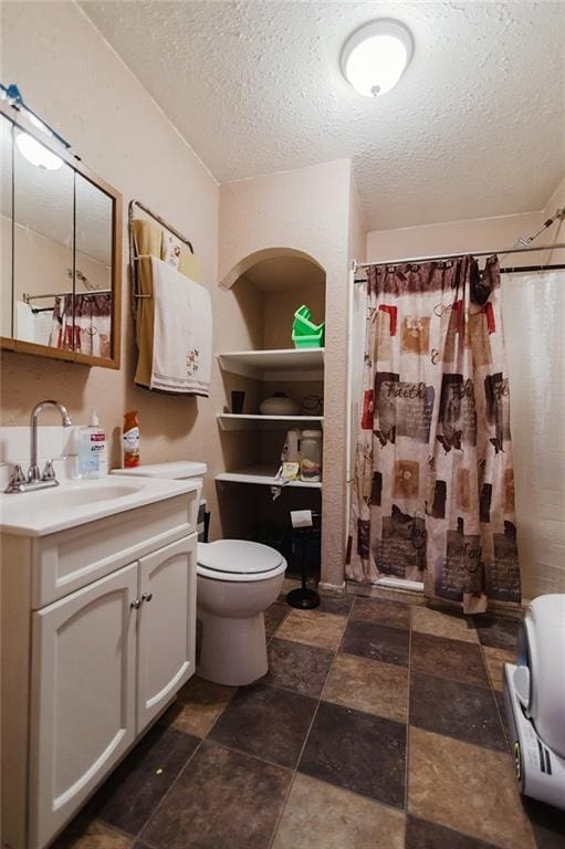 929 N 7th St, Atchison, KS 66002 - full bathroom with toilet, vanity, a textured ceiling, stone finish floors, and a shower with shower curtain