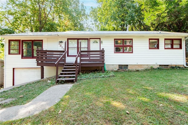 view of front of house with a front yard, a garage, and a wooden deck