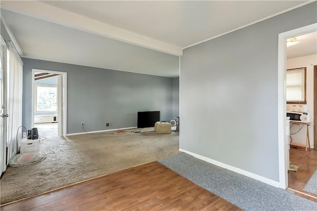 unfurnished living room with carpet and beamed ceiling