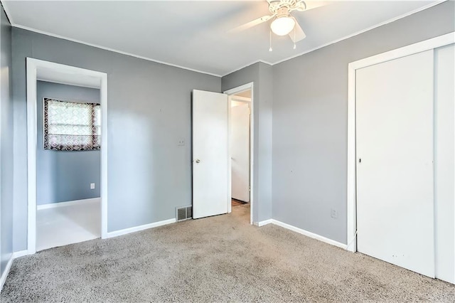 unfurnished bedroom with ceiling fan and light colored carpet