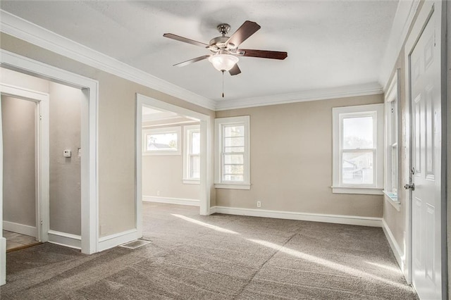 carpeted empty room with ornamental molding and ceiling fan