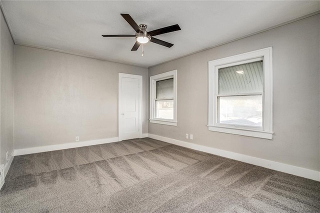 spare room featuring carpet flooring and ceiling fan