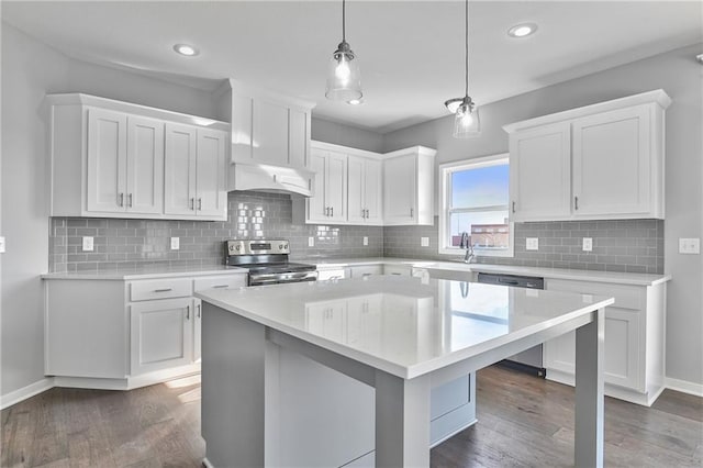 kitchen with a center island, hanging light fixtures, dark hardwood / wood-style flooring, stainless steel appliances, and white cabinets